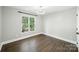 This bedroom is bathed in natural light, featuring beautiful hardwood floors, and bright white trim at 17101 Windy Oaks Ct, Cornelius, NC 28031