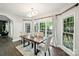 Inviting dining room with hardwood floors, a modern chandelier, and plenty of natural light at 17101 Windy Oaks Ct, Cornelius, NC 28031