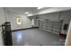 Spacious garage with epoxy floors, bright lighting, and a roll-up door at 17101 Windy Oaks Ct, Cornelius, NC 28031