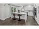 Stylish kitchen with a waterfall island, sleek countertops, and modern stainless steel appliances at 17101 Windy Oaks Ct, Cornelius, NC 28031