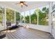 Screened porch with wood floors and views of the beautiful backyard at 17101 Windy Oaks Ct, Cornelius, NC 28031