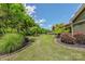 Manicured backyard featuring lush landscaping, vibrant flowers, and a charming patio area at 1905 Tranquility Blvd, Lancaster, SC 29720