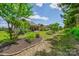 Expansive backyard with manicured lawn, mature trees, and a patio perfect for outdoor gatherings at 1905 Tranquility Blvd, Lancaster, SC 29720