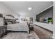 Main bedroom features large windows, dark accent wall, and light gray rug at 1905 Tranquility Blvd, Lancaster, SC 29720