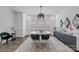 Bright dining room with modern light fixture, gray accent console and decorative mirrors at 1905 Tranquility Blvd, Lancaster, SC 29720