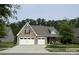 Charming, two-story home featuring a stone facade, manicured lawn, and a two-car garage at 1905 Tranquility Blvd, Lancaster, SC 29720