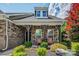 Inviting front porch with stone pillars and seating surrounded by colorful landscaping at 1905 Tranquility Blvd, Lancaster, SC 29720