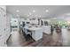 Open-concept kitchen featuring a large island, white cabinetry, and stainless steel appliances at 1905 Tranquility Blvd, Lancaster, SC 29720