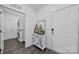 Bright laundry room with washer and dryer in hallway by decorative cabinet at 1905 Tranquility Blvd, Lancaster, SC 29720