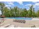Large community pool surrounded by trees and lounge chairs, perfect for relaxation at 1905 Tranquility Blvd, Lancaster, SC 29720