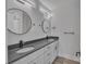 Bathroom featuring double vanity with matte fixtures, round mirrors and gray countertop at 1933 St Mark St, Charlotte, NC 28216
