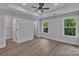 Spacious bedroom featuring a ceiling fan, natural light, and wood-look floors at 1933 St Mark St, Charlotte, NC 28216