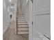 View of a staircase with wood treads and white risers, complemented by light-colored walls and wood-look floors at 1933 St Mark St, Charlotte, NC 28216