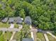 An aerial view of a two-story home with a two-car garage surrounded by lush trees and neighborhood streets at 1935 St Mark St, Charlotte, NC 28216