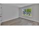 Bedroom with a view of a quaint neighborhood through a bright window at 1935 St Mark St, Charlotte, NC 28216