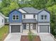 Charming townhouse featuring two-car garages, craftsman-style accents, and a well-manicured front yard at 1935 St Mark St, Charlotte, NC 28216