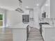 Bright kitchen with white cabinets, stainless steel appliances, and an island with pendant lighting at 1935 St Mark St, Charlotte, NC 28216