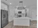 Modern kitchen with white cabinets, stainless steel appliances, and island with a sleek faucet at 1935 St Mark St, Charlotte, NC 28216
