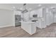 Modern kitchen featuring white cabinets, stainless steel appliances, and a stylish center island at 1935 St Mark St, Charlotte, NC 28216