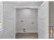 A laundry room ready for appliances, featuring utility hookups and wood grain vinyl floors at 1935 St Mark St, Charlotte, NC 28216