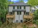 Rear exterior of a white two-story home featuring wood decks and many windows overlooking the backyard at 1935 St Mark St, Charlotte, NC 28216