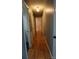 Hallway featuring hardwood floors, neutral walls, and access to multiple rooms and storage at 1958 19Th Avenue Ne Dr # 8, Hickory, NC 28601