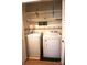 Functional laundry room boasts a washer, dryer, and upper shelving for storage at 1958 19Th Avenue Ne Dr # 8, Hickory, NC 28601