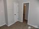 Cozy bedroom with neutral walls, fresh carpet, and a doorway to another room at 209 Barber Rd, Gastonia, NC 28056