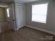 Bedroom featuring plush carpeting, closet, and a bright window, freshly painted at 209 Barber Rd, Gastonia, NC 28056