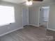A bedroom showing neutral walls, a ceiling fan, new flooring, and a bright window at 209 Barber Rd, Gastonia, NC 28056