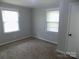 Cozy bedroom features new carpet, neutral walls, and bright natural light from two windows at 209 Barber Rd, Gastonia, NC 28056