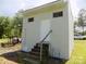 Outbuilding with painted cinder blocks, white trim, a window, front door and weathered concrete steps at 209 Barber Rd, Gastonia, NC 28056