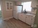 Bright kitchen with white cabinetry, granite countertops, stainless steel sink and white appliances at 209 Barber Rd, Gastonia, NC 28056