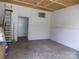 Spacious outbuilding interior with concrete floor, ladder and open door ready for storage or workshop at 209 Barber Rd, Gastonia, NC 28056