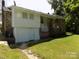 View of the back of the house with a walk out basement and access to the backyard at 209 Barber Rd, Gastonia, NC 28056