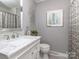 Stylish bathroom with a marble vanity, framed mirror, and decorative shower curtain at 214 Wilcrest Dr, Matthews, NC 28105