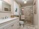 Contemporary bathroom with a glass shower, white vanity, and neutral color scheme at 214 Wilcrest Dr, Matthews, NC 28105