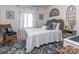 Charming bedroom featuring cozy bed, wicker chair, and bright floral curtains at 214 Wilcrest Dr, Matthews, NC 28105