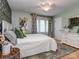 Inviting bedroom with light green walls, hardwood floors, and lots of natural light at 214 Wilcrest Dr, Matthews, NC 28105