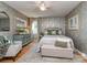 Serene bedroom with a patterned accent wall, a plush bed, and a vintage dresser at 214 Wilcrest Dr, Matthews, NC 28105