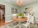 Quaint dining room featuring a round table with light green walls and decorative pendant lighting at 214 Wilcrest Dr, Matthews, NC 28105