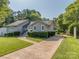 Inviting single-story home with a neatly paved driveway and professionally landscaped front yard at 214 Wilcrest Dr, Matthews, NC 28105