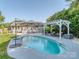 Backyard featuring a private in-ground pool, surrounding patio, and a charming pergola at 214 Wilcrest Dr, Matthews, NC 28105