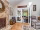 Sunlit room featuring a stone fireplace and opens to a relaxing sun room with wicker furnishings at 214 Wilcrest Dr, Matthews, NC 28105