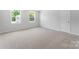 A spacious bedroom is filled with light from two large windows and plush carpet at 217 Basildon St # 1018, Lancaster, SC 29720