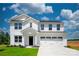 Beautiful two-story home with a crisp white facade, attached two car garage, and manicured lawn at 217 Basildon St # 1018, Lancaster, SC 29720