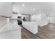 A full kitchen view features white cabinets and countertops with stainless steel appliances at 217 Basildon St # 1018, Lancaster, SC 29720