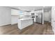 A kitchen boasts stainless steel appliances, wood flooring and white cabinets and countertops at 217 Basildon St # 1018, Lancaster, SC 29720