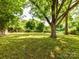 Expansive backyard with lush greenery and shade trees, perfect for outdoor activities and relaxation at 22 Walnut Nw Ave # 1, Concord, NC 28027