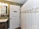 Practical bathroom featuring a vanity, mirror, and shower with a patterned curtain at 22 Walnut Nw Ave # 1, Concord, NC 28027